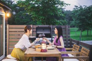 two women sitting at a table drinking wine at cottage - Vacation STAY 02033v in Shinano