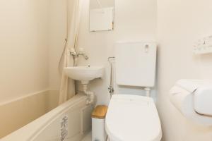 a white bathroom with a toilet and a sink at cottage - Vacation STAY 02033v in Shinano