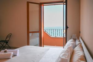 a bedroom with a bed with a view of the ocean at Il Porticciolo in Scilla +31 photos