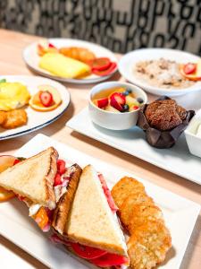 a table topped with plates of food with sandwiches and dips at Four Points by Sheraton Kelowna Airport in Kelowna