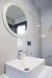a white bathroom with a sink and a mirror at Elite estate in Podstrana +31 photos