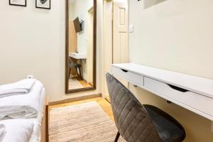 a dressing room with a mirror and a chair at ApartPro Apartments, Veliko Tarnovo in Veliko Tŭrnovo +36 photos