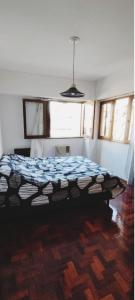 a bedroom with a bed in a room with windows at Departamento calle España in Mendoza
