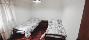 a bedroom with two beds in a room at Departamento calle España in Mendoza