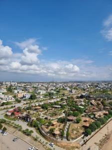 an overhead view of a city with houses and trees at Three Bed Attached Bath Netflix Wifi Smart TV Parking WFH Desk Near Airport in Islamabad