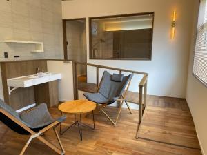a kitchen with two chairs and a table and a counter at MAISON DE AILE - Vacation STAY 58600v in Amami