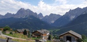 a group of houses in front of some mountains at Casetta con camino in La Magdeleine