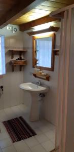 a bathroom with a sink and a window at Casetta con camino in La Magdeleine +10 photos