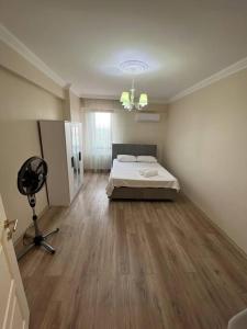 a room with a bed and a fan in it at Villam in Kartepe