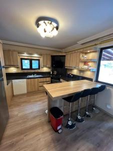 a kitchen with a table and stools in it at Villam in Kartepe