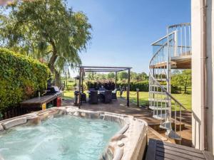 a hot tub in the backyard of a house at Melsham House in Freethorpe