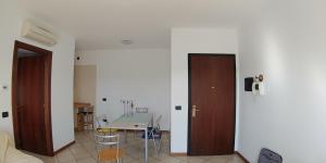 a room with two doors and a table with chairs at Villa4Holydays - M1 subway in Milan