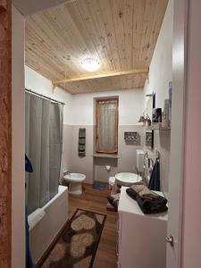 a bathroom with a tub and a sink and a toilet at Borgo Carletto Roburent - Immersi nella natura in San Giacomo