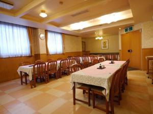 a conference room with tables and chairs in it at Hotel Fukui Castle - Vacation STAY 58692v in Fukui