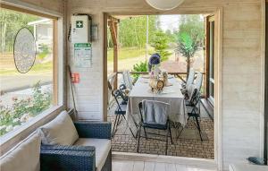 a screened in porch with a table and chairs at Pet Friendly Home In Insko With Outdoor Swimming Pool in Ińsko