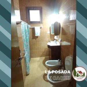 a bathroom with a toilet and a sink at La Posada De Cacho in San Rafael