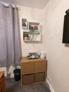 a small wooden cabinet in a room with a window at Large Cosy Room to Stay in South Reading in Shinfield