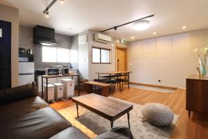 a living room with a couch and a table at HAKATA TERRACE -Toki- - Vacation STAY 14934 in Fukuoka