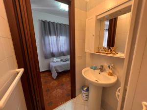 a bathroom with a sink and a mirror at Celeste Rooms in San Vito lo Capo