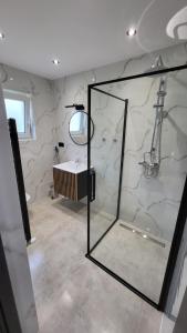 a bathroom with a glass shower and a sink at Domki i Pokoje u Ilony in Krościenko