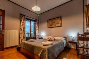 a bedroom with a bed and a large window at Thalia's Abode in Agios Lavredios