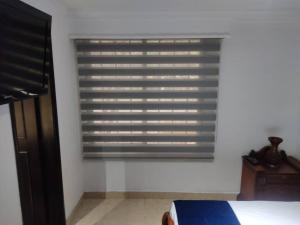 a window in a room with a bed and a table at bonito y bien ubicado apto. in Itagüí