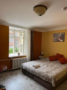 a bedroom with a large bed and a window at Godart Rooms Guesthouse in Tallinn