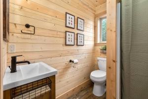 a bathroom with a white sink and a toilet at Thunderbird Ridge - Cabin 1 - Summit in Polebridge