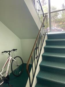 a bike parked next to a staircase in a house at Exquisite 2 Bedroom Apartment in Camrose