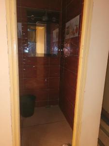 a bathroom with a shower with brown tile at khenifra in Khenifra