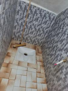 a bathroom with a toilet in the middle of the floor at khenifra in Khenifra