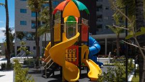 a playground with a slide in a park at SALINAS PREMIUM RESORT in Salinópolis
