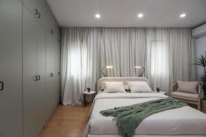 a bedroom with a large bed with a green blanket on it at +25Y ONLY, Family flat near the beach in Barcelona