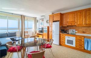 a kitchen with a glass table and a kitchen with a couch at Gorgeous Apartment In Mlaga With House Sea View in Málaga