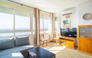 a living room with a couch and a flat screen tv at Gorgeous Apartment In Mlaga With House Sea View in Málaga