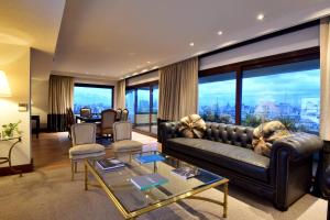 a living room with a couch and a large window at Marriott Buenos Aires Downtown in Buenos Aires +82 photos