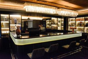 a bar in a restaurant with chairs and chandeliers at Buenos Aires Marriott in Buenos Aires