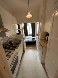 a kitchen with a sink and a stove top oven at Home Inn BG11 in Stockholm