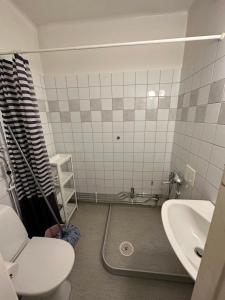 a bathroom with a toilet and a sink at Home Inn BG11 in Stockholm