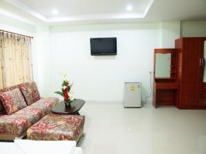 a living room with a couch and a tv at Ruan Rim Nam in Roi Et