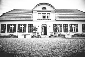 a black and white photo of a house at Gutshaus mit Seeblick - ökologisch & nachhaltig in Lübow