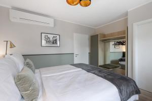 Postel nebo postele na pokoji v ubytování Living Ascona Boutique Hotel