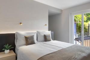 Postel nebo postele na pokoji v ubytování Living Ascona Boutique Hotel