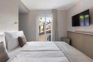 Postel nebo postele na pokoji v ubytování Living Ascona Boutique Hotel