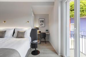 Postel nebo postele na pokoji v ubytování Living Ascona Boutique Hotel