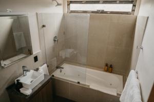 a bathroom with a tub and a sink and a shower at Mineral del Cielo in Mineral de Pozos