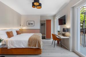 アスコナにあるLiving Ascona Boutique Hotel - Smart Hotelのベッドルーム1室(ベッド1台、デスク、窓付)
