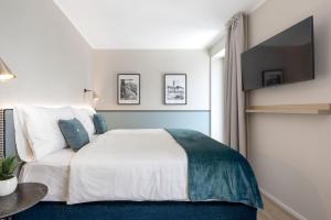 Postel nebo postele na pokoji v ubytování Living Ascona Boutique Hotel