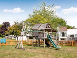 un parque infantil con una casa en el árbol y un tobogán en Number 13, en Gunnislake