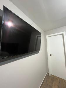 a large flat screen tv hanging on a wall at Cobertura in Florianópolis